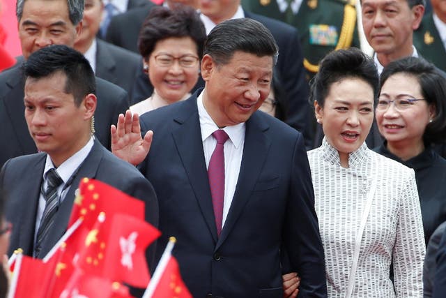 Chinese President Xi Jinping and his wife Peng Liyuan arrive in Hong Kong