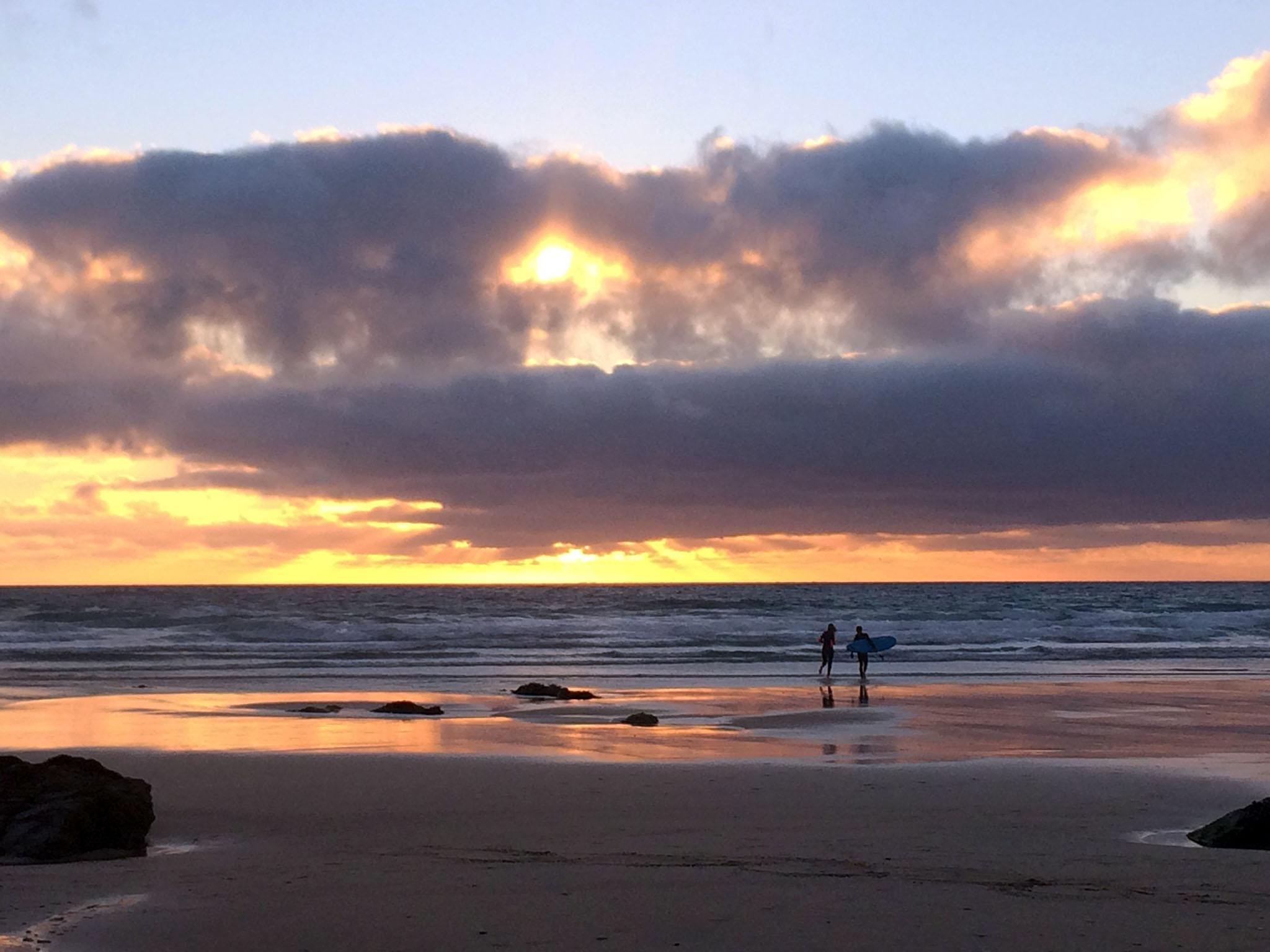 After a long day of surfing, take in the stunning sunset on Fistral Beach