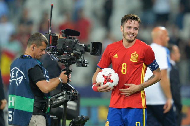 Saul Niguez claims the match ball after his semi-final hat-trick against Italy