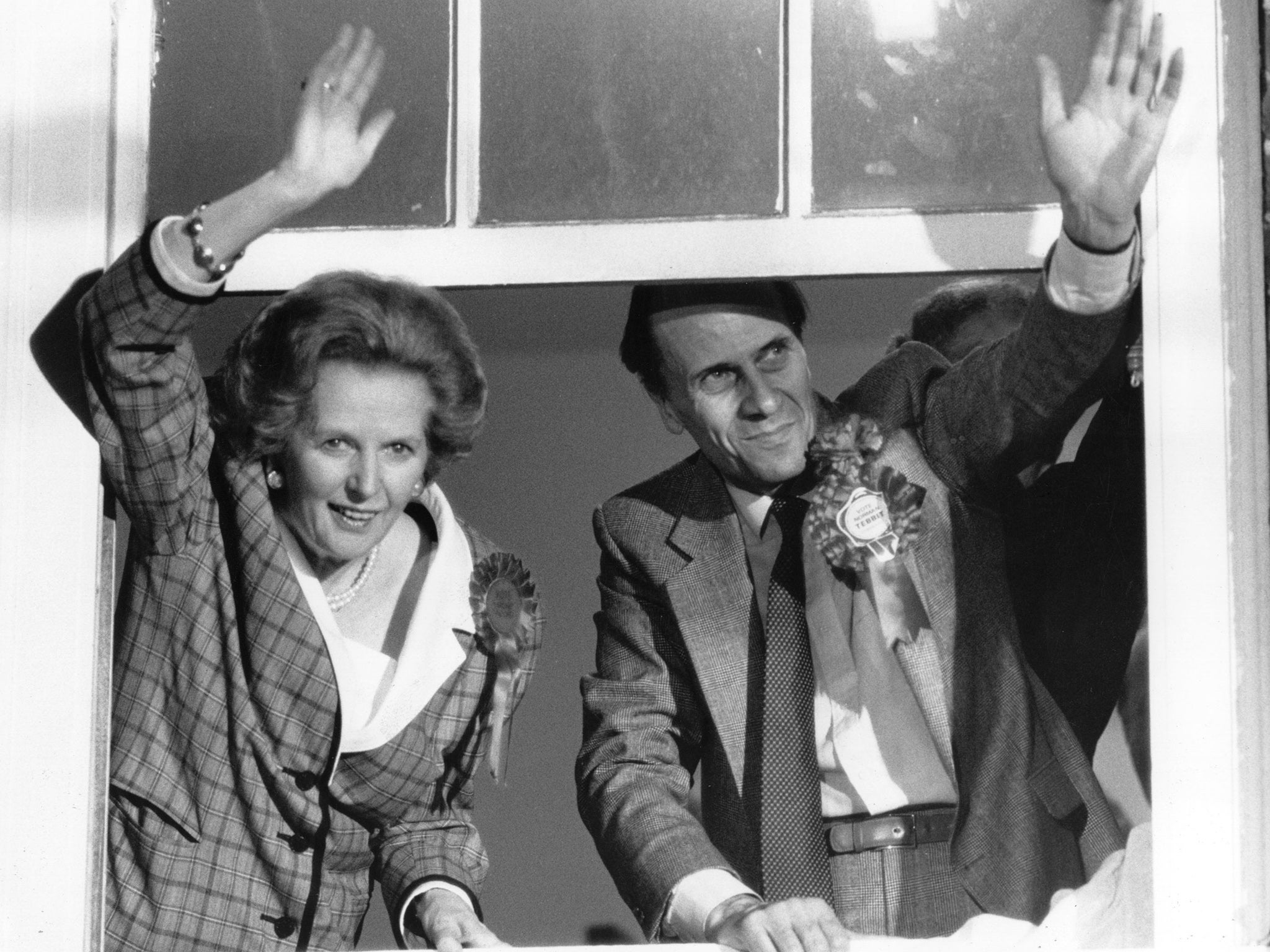&#13;
Margaret Thatcher and Norman Tebbit waving to supporters from the Conservative Headquarters on election night in 1983 (Getty)&#13;