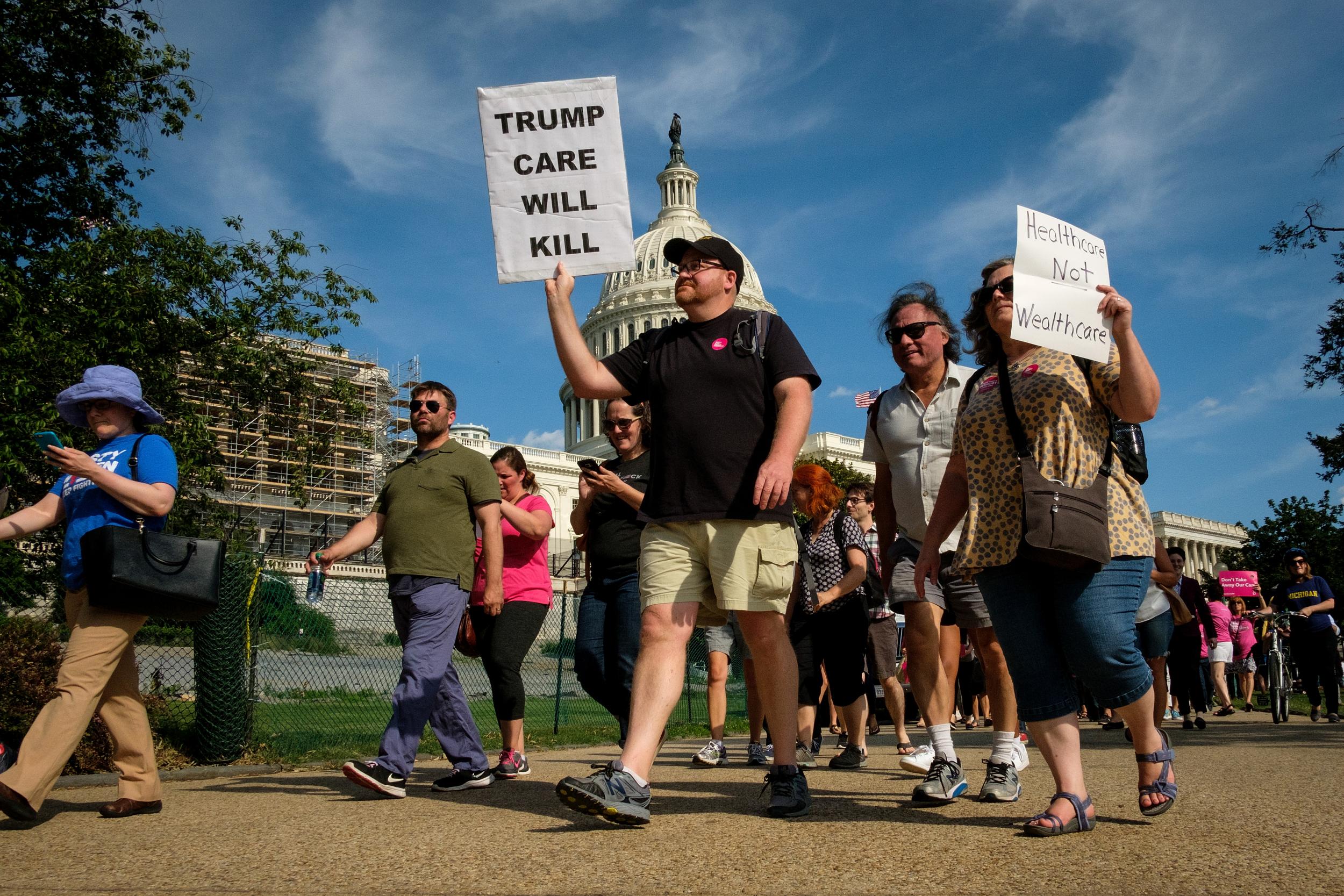 Activists march around the US Capitol to protest the Senate Republicans' health care bill