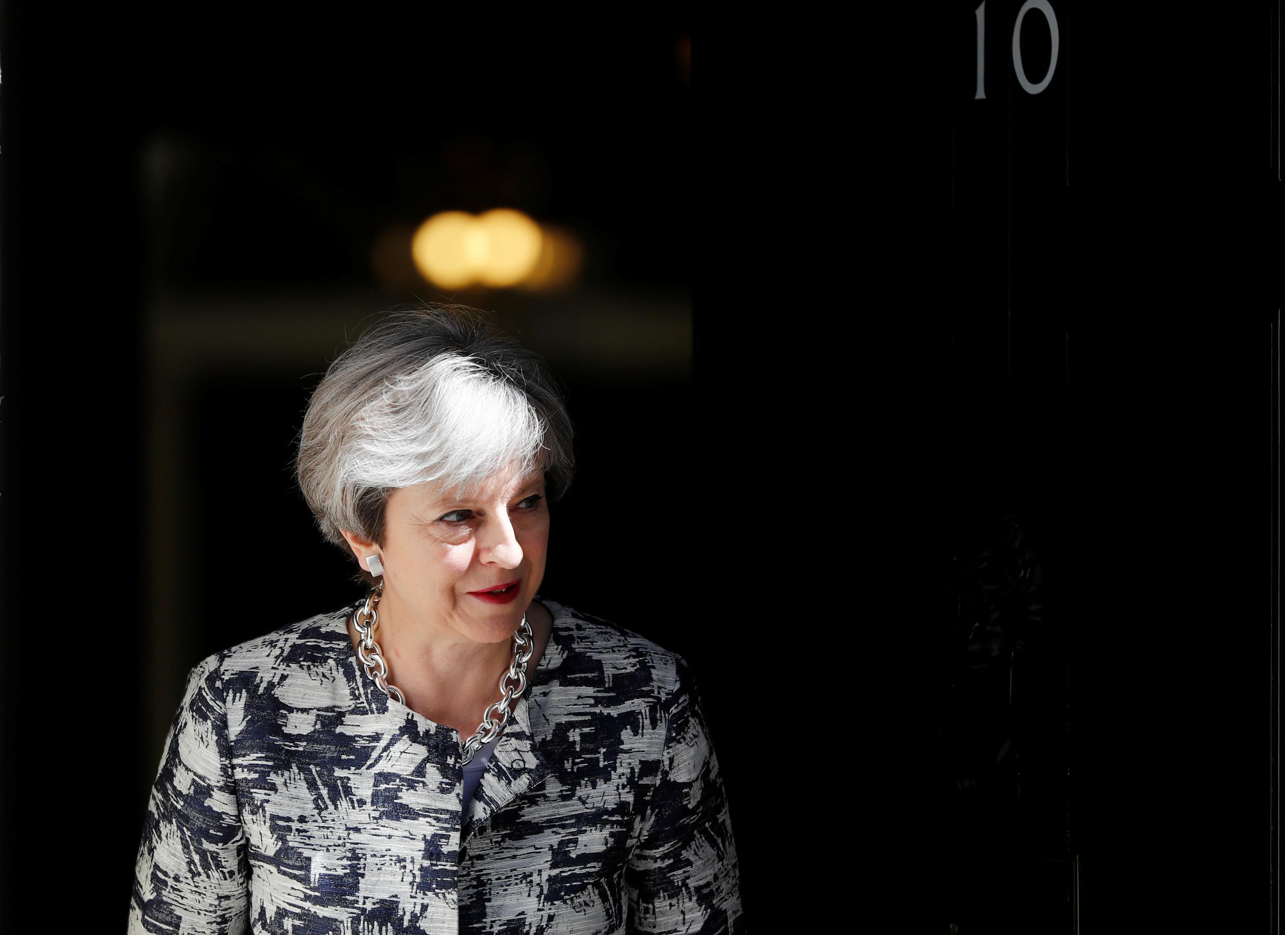 Britain's Prime Minister, Theresa May, waits to greet Democratic Unionist Party (DUP) Leader Arlene Foster, in Downing Street, in central London, Britain June 26, 2017