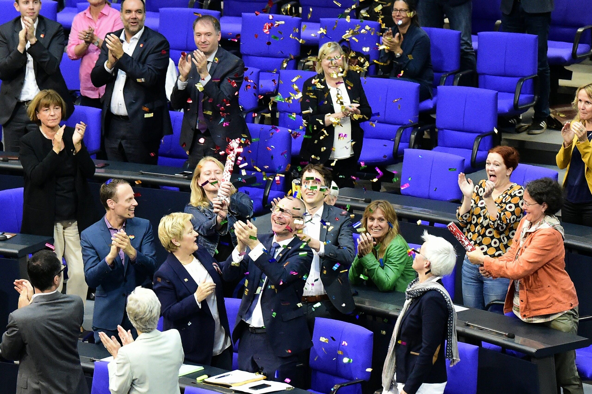 TOPSHOT - MP¥s from the Green party celebrate with confetti following a debate and vote on same-sex marriage in Bundestag, Germany¥s lower house of Parliament in Berlin on June 30, 2017.
A clear majority of German MPs voted to legalise same-sex marriage, days after Chancellor Angela Merkel dropped her opposition to the idea. / AFP PHOTO / Tobias SCHWARZTOBIAS SCHWARZ/AFP/Getty Images