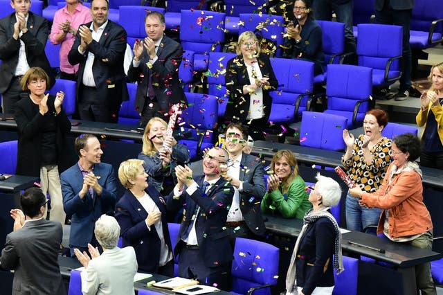 TOPSHOT - MP?s from the Green party celebrate with confetti following a debate and vote on same-sex marriage in Bundestag, Germany?s lower house of Parliament in Berlin on June 30, 2017.
A clear majority of German MPs voted to legalise same-sex marriage, days after Chancellor Angela Merkel dropped her opposition to the idea. / AFP PHOTO / Tobias SCHWARZTOBIAS SCHWARZ/AFP/Getty Images