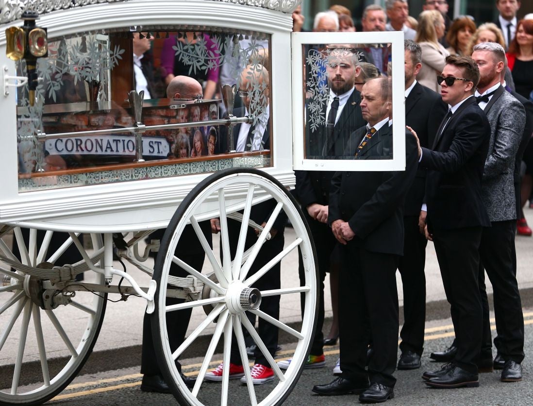 Martyn Hett's father Paul Hett stands by the coffin of his son as it arrives at Stockport Town Hall for his funeral