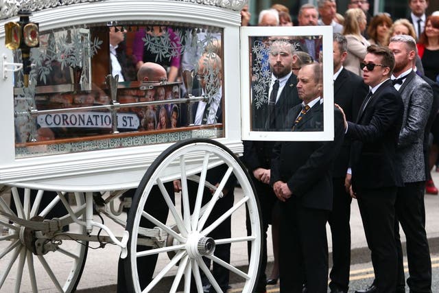 Martyn Hett's father Paul Hett stands by the coffin of his son as it arrives at Stockport Town Hall for his funeral