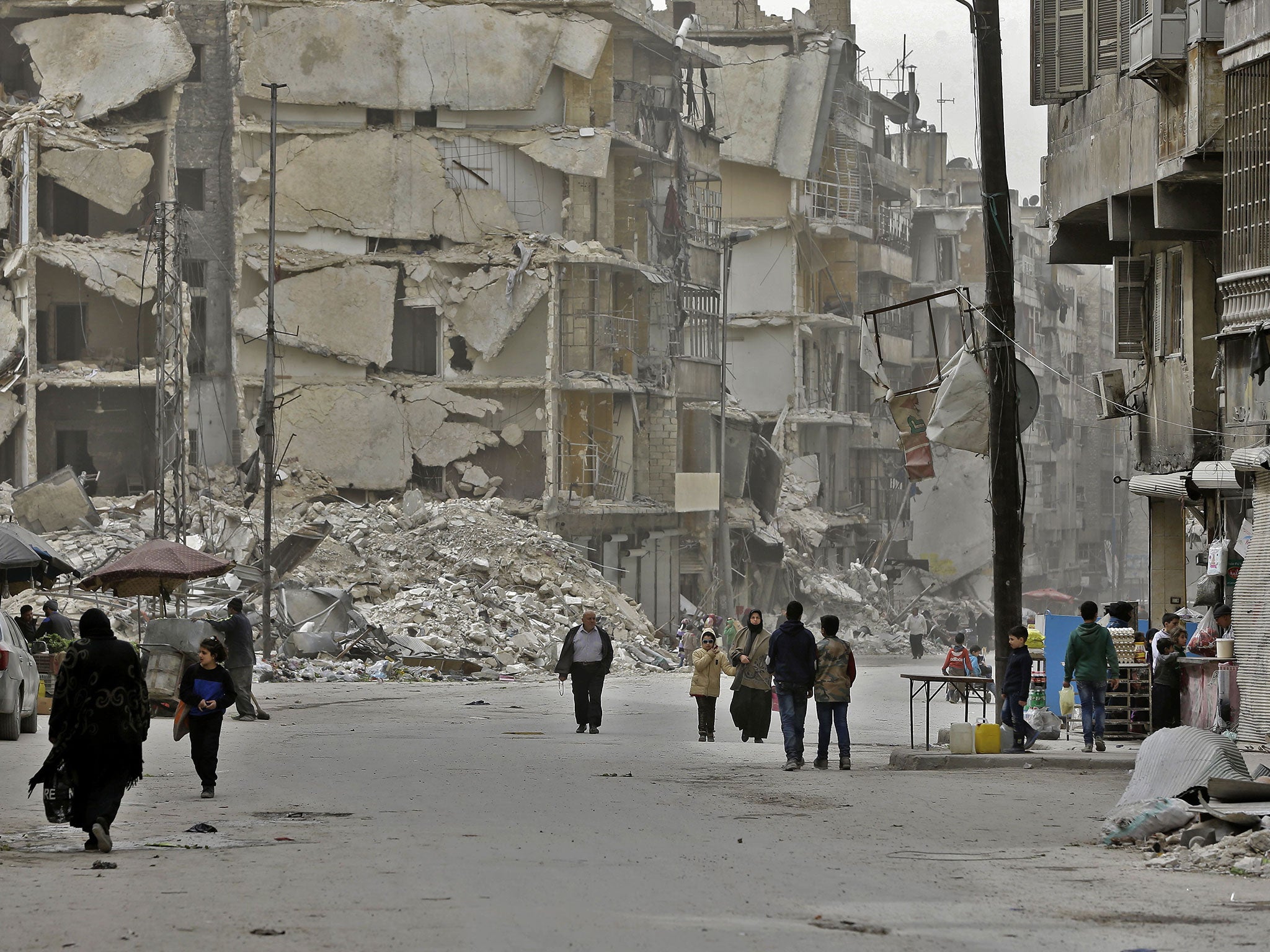 Residents in the formerly rebel-held al-Shaar district of Aleppo on 9 March 2017