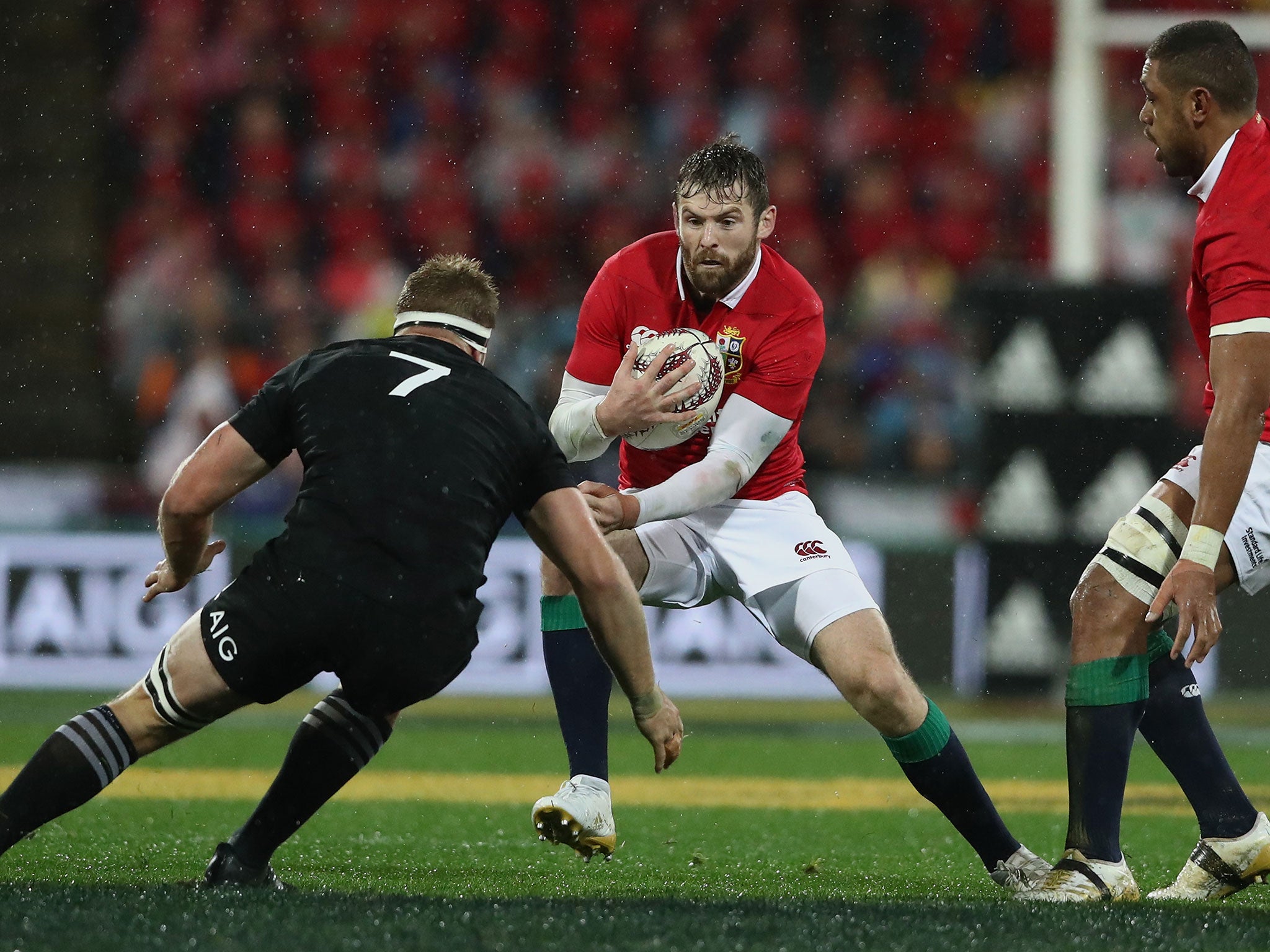 Elliot Daly attempts to avoid a tackle from Sam Cane