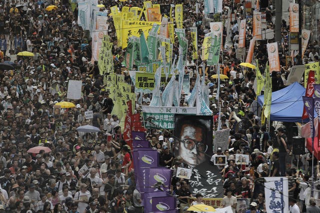 Protesters carry a large image of jailed Chinese Nobel Peace laureate Liu Xiaobo as they march during the annual pro-democracy protest in Hong Kong, Saturday, July 1, 2017