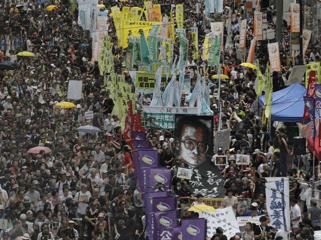Protesters carry a large image of jailed Chinese Nobel Peace laureate Liu Xiaobo as they march during the annual pro-democracy protest in Hong Kong, Saturday, July 1, 2017
