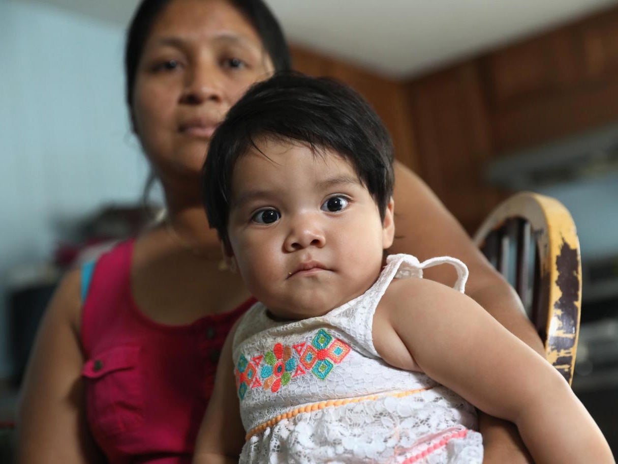 Undocumented immigrant Guadalupe Lopez, 34, holds one of her five US-born children