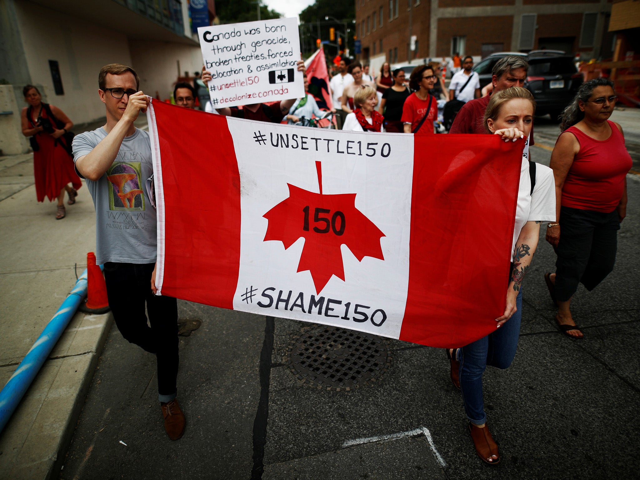 Indigenous rights activists march after in the ‘Unsettle Canada Day 150 Picnic’, as the country marks its 150th anniversary