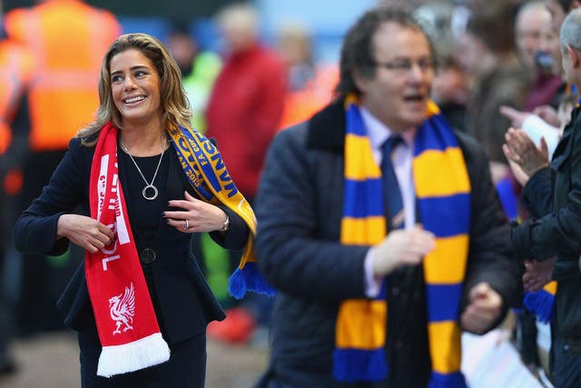 Carolyn Radford, with her husband John in the foreground, has called for greater female representation in the business side of football
