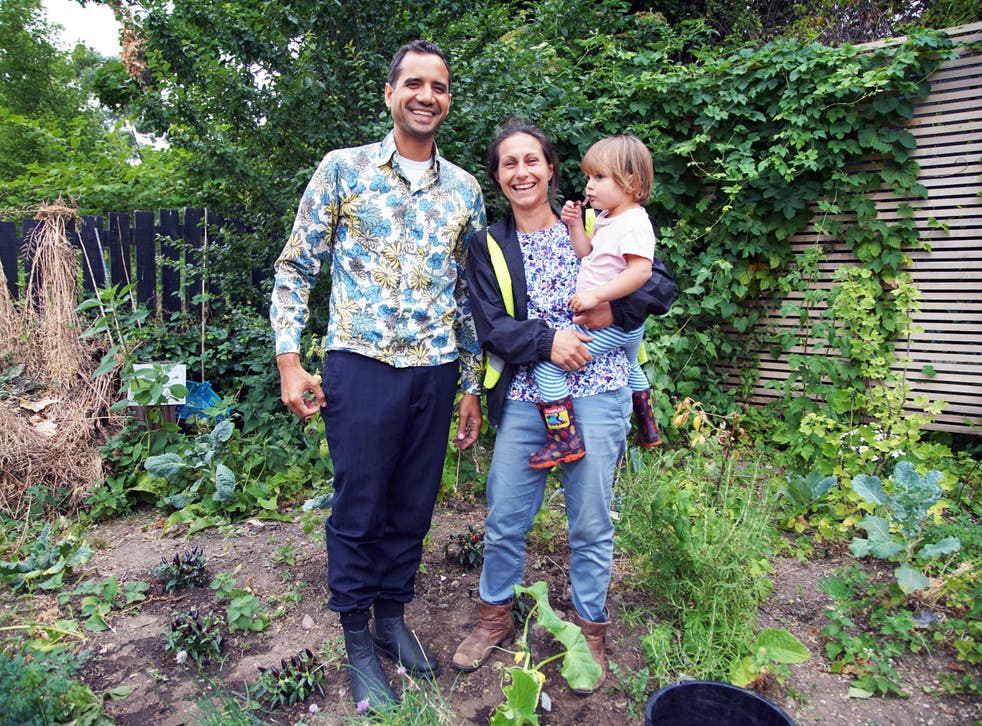 Agamemnon Otero, co-founder of Repowering London, with Patti Zogolovitch and her daughter Floretta in the Energy Garden at Brondesbury Park Overground station in London
