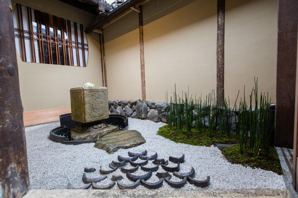 Outside, a picturesque garden comes complete with stone water basins and sculptures