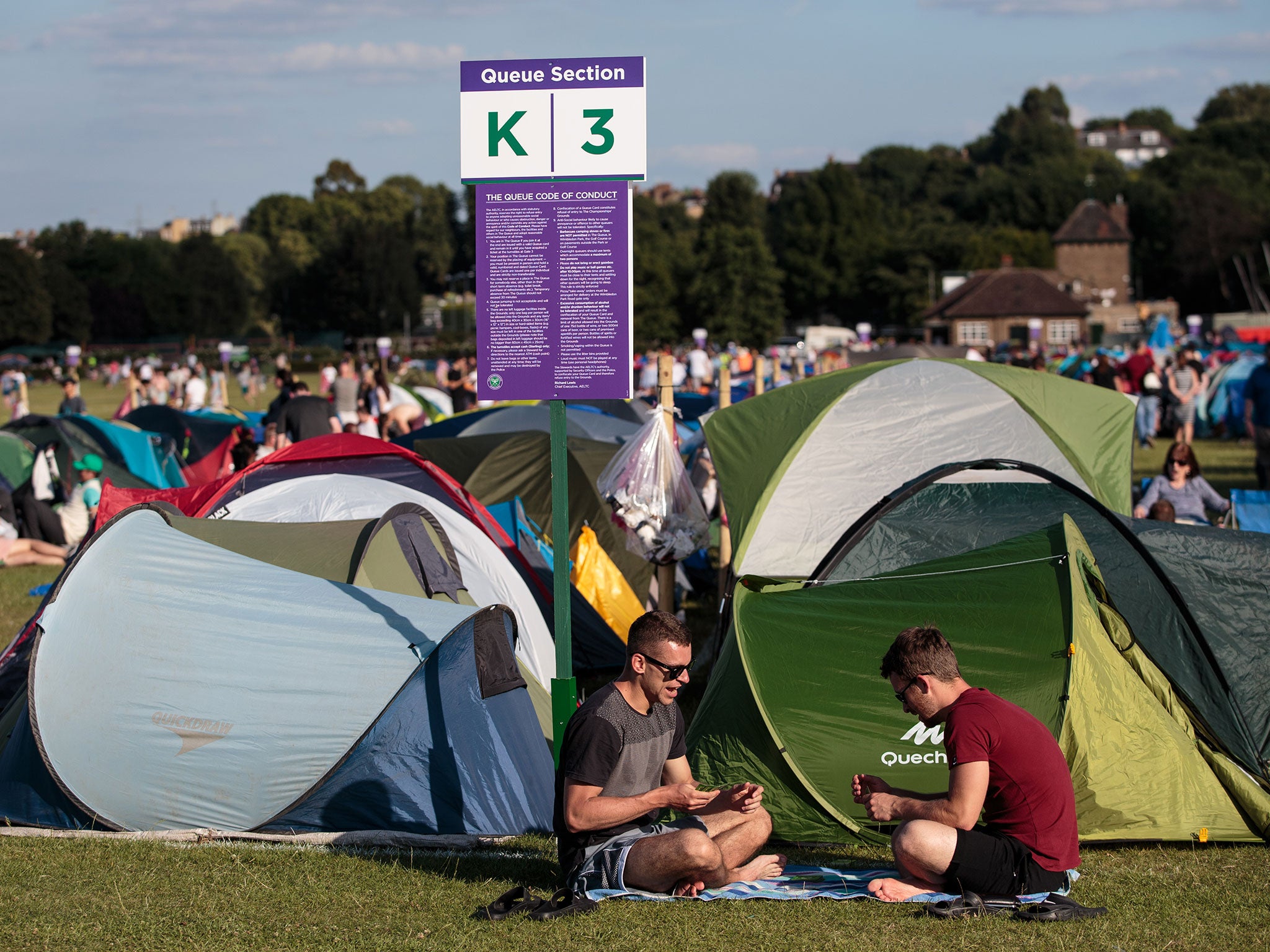 Wimbledon fans patiently wait on the morning of the opening day