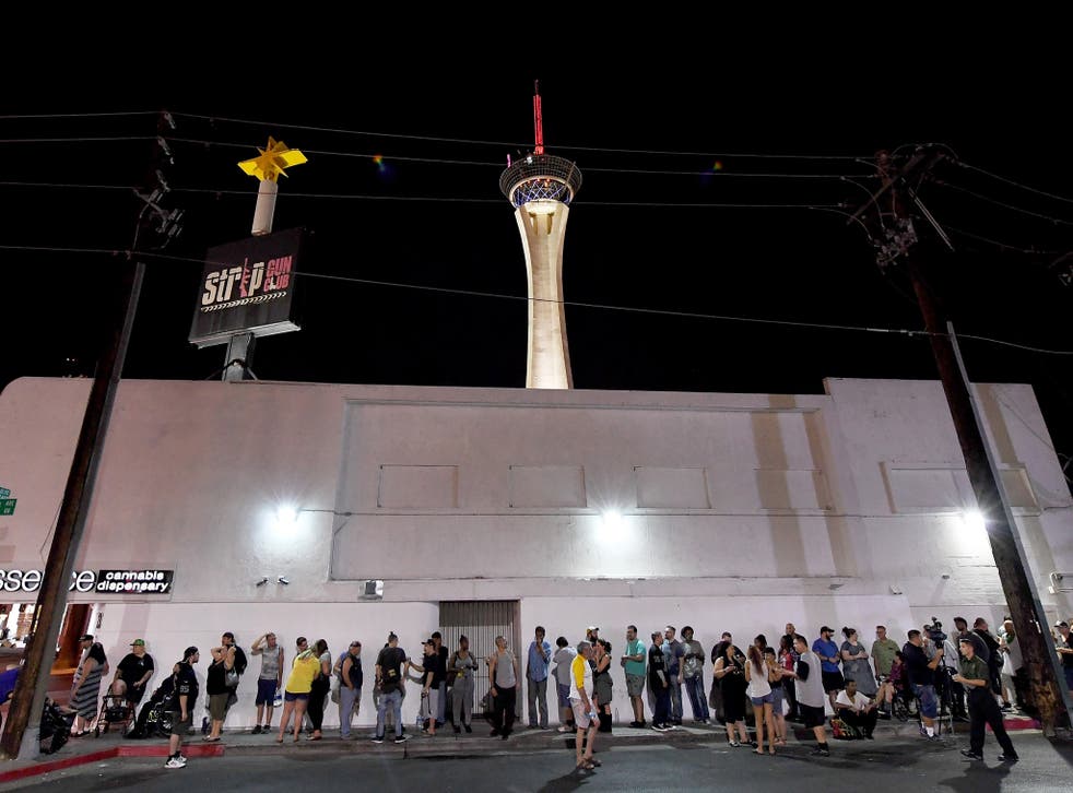 Customers line up outside Essence Vegas Cannabis Dispensary as they wait for the midnight start of recreational marijuana sales to begin
