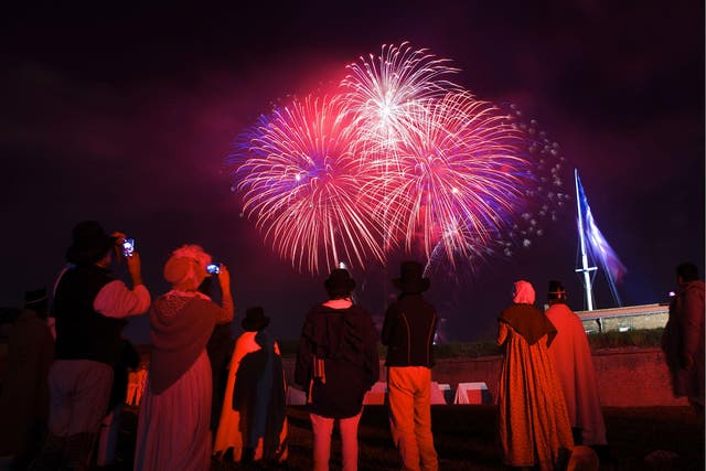 <p>War of 1812 re-enactors watch a fireworks display following a ceremony to commemorate the bicentennial of the writing of ‘The Star-Spangled Banner’ at Fort McHenry National Historic Park in Baltimore, Maryland </p>