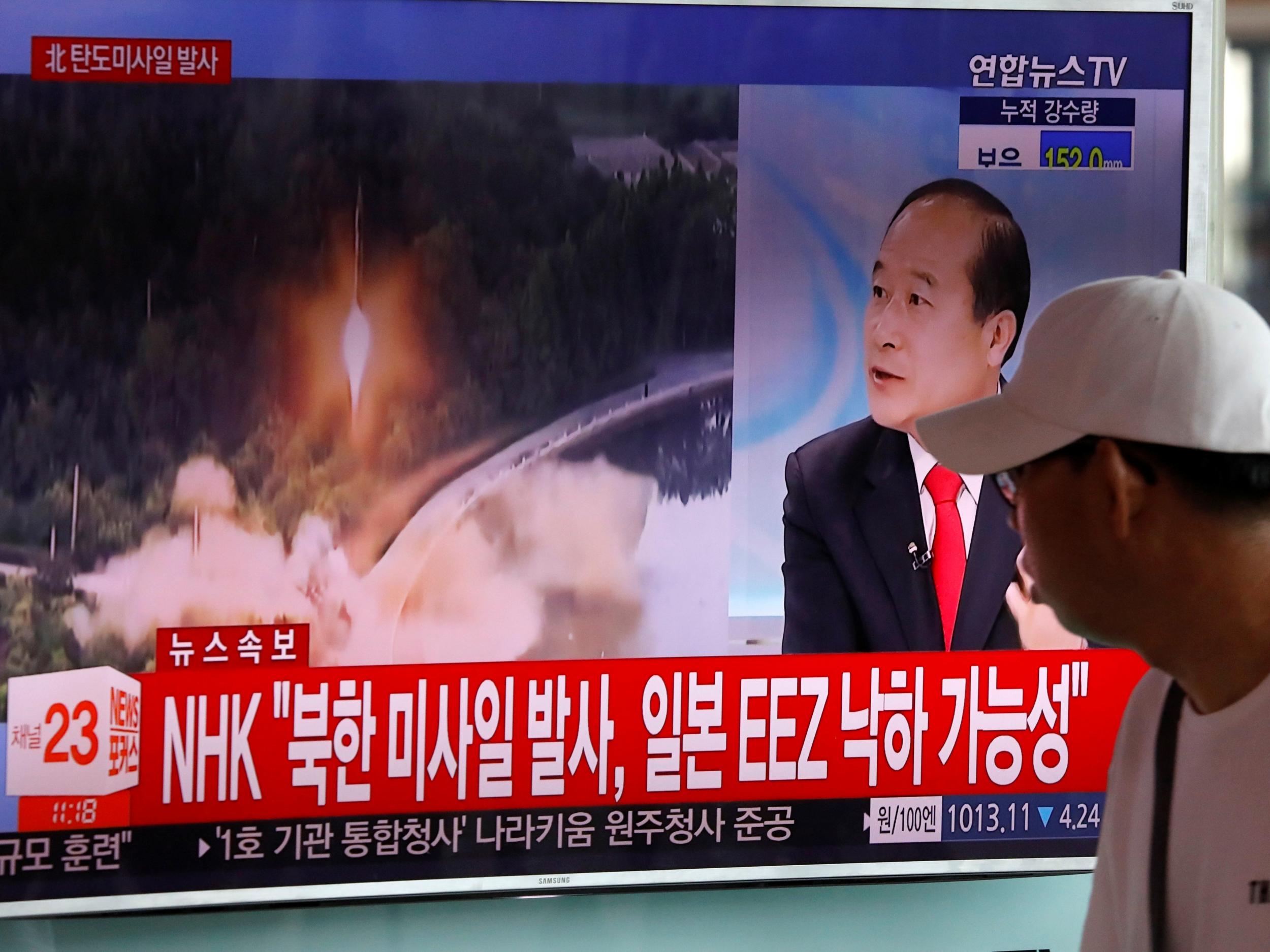 A man watches a TV broadcast of a news report on North Korea's ballistic missile test at a railway station in Seoul, South Korea