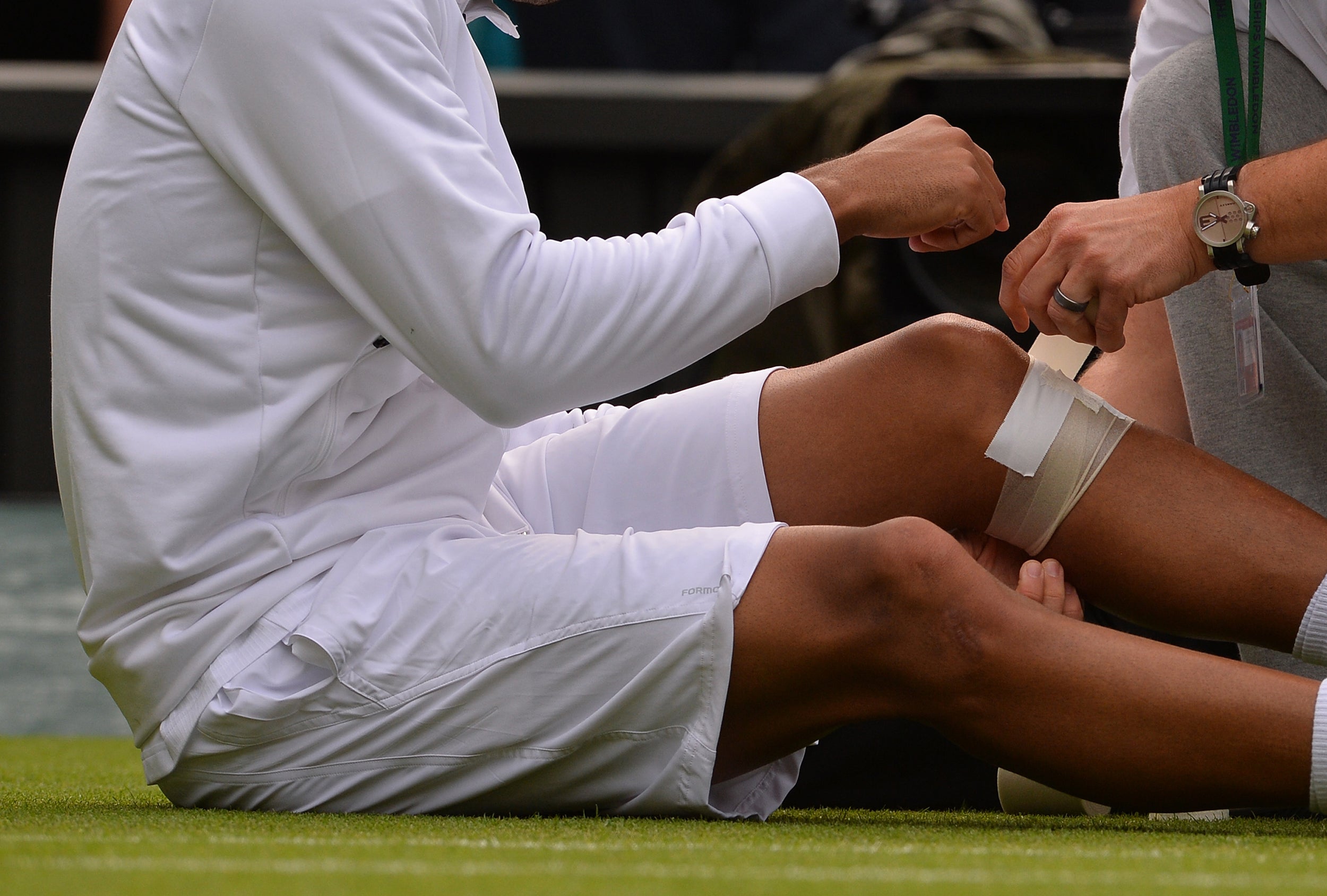 France’s Jo-Wilfried Tsonga receives attention to his leg during the Wimbldeon tournament in 2013 (AFP/Getty)
