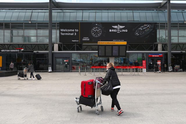 A passenger pushes luggage at Heathrow Terminal Three in London, Britain May 5, 2017