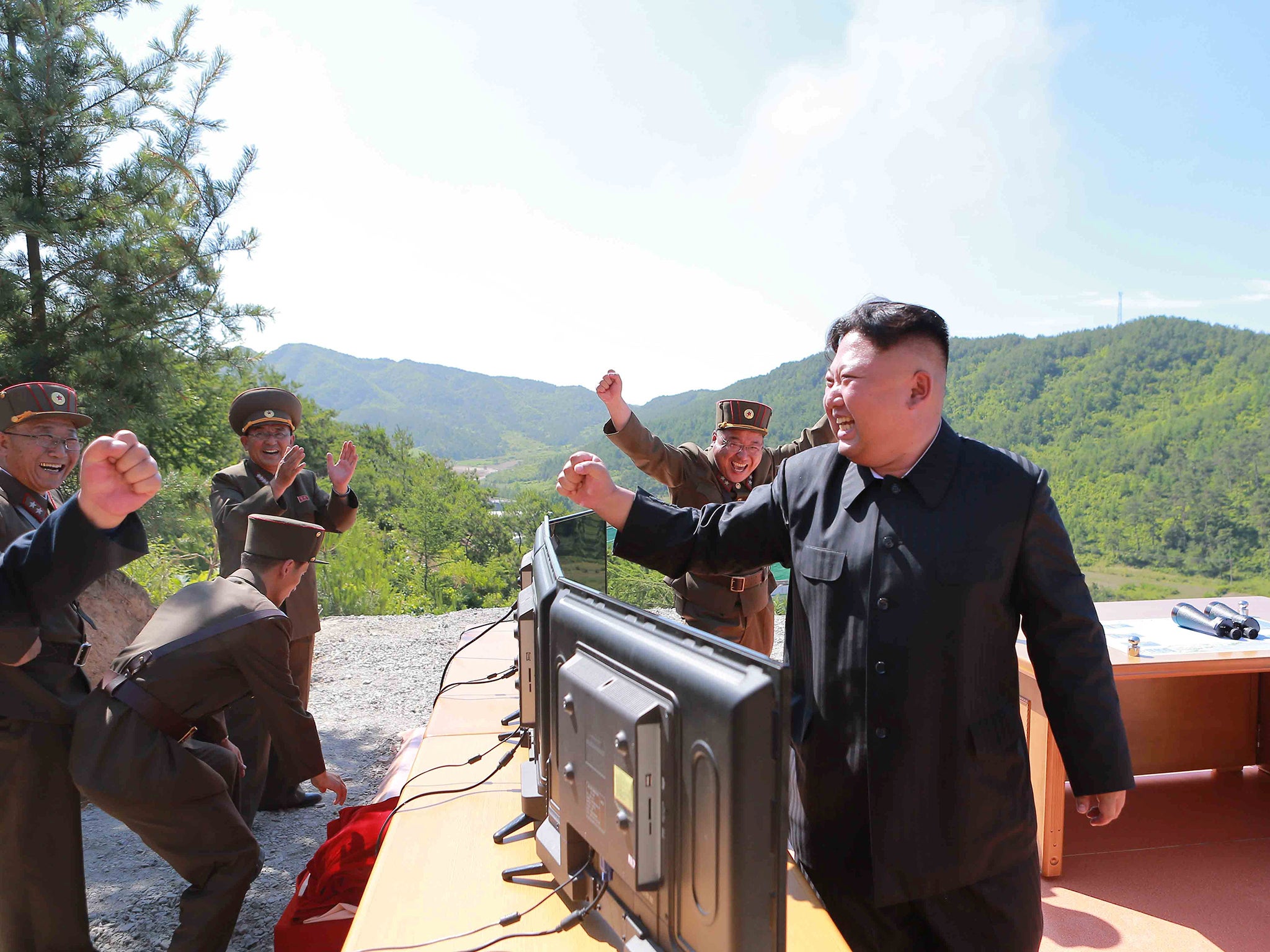North Korean Leader Kim Jong-un reacts during the test-fire of intercontinental ballistic missile Hwasong-14 in this undated photo released by North Korea's Korean Central News Agency