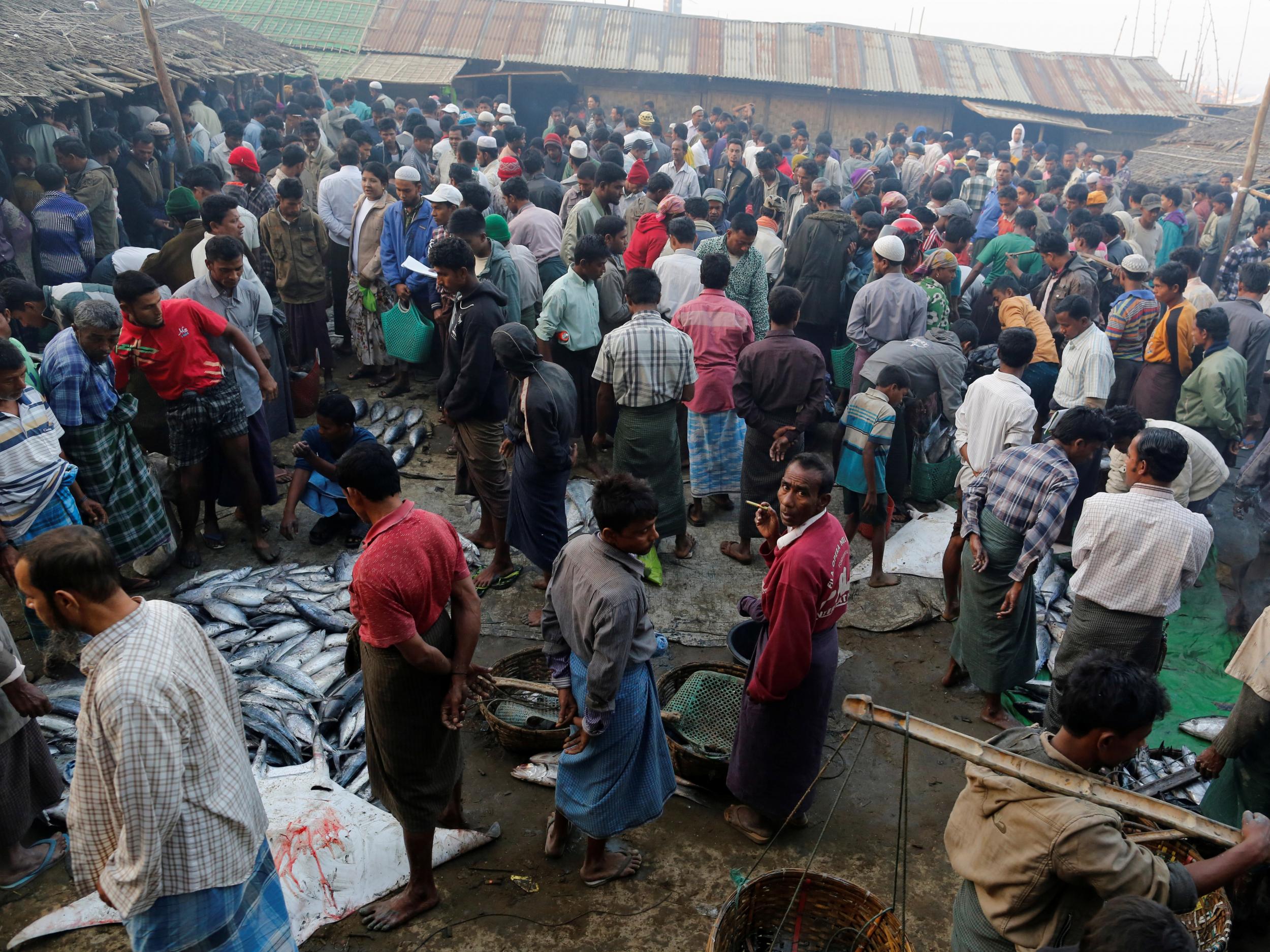 Rohingya men at Sittwe’s bustling fish market in Rakhine, Burma (Reuters)