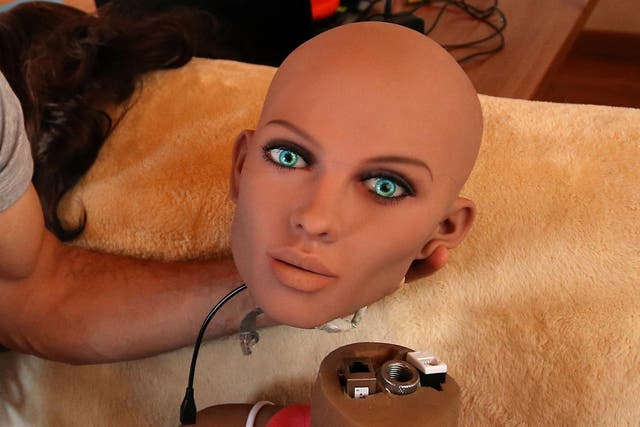 Catalan nanotechnology engineer Sergi Santos holds the head of Samantha, a sex doll packed with artificial intelligence providing her the capability to respond to different scenarios and verbal stimulus
