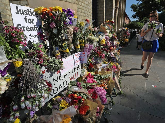 Tributes to the victims left outside the tower block where at least 80 people died