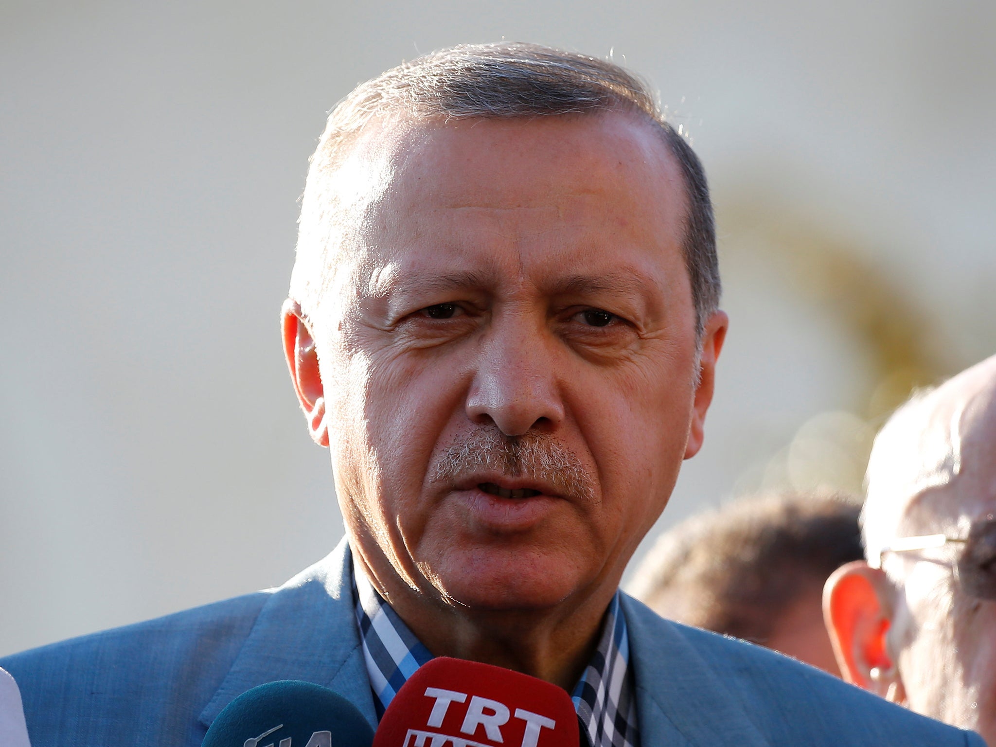 Turkey's President Recep Tayyip Erdogan talks to media
