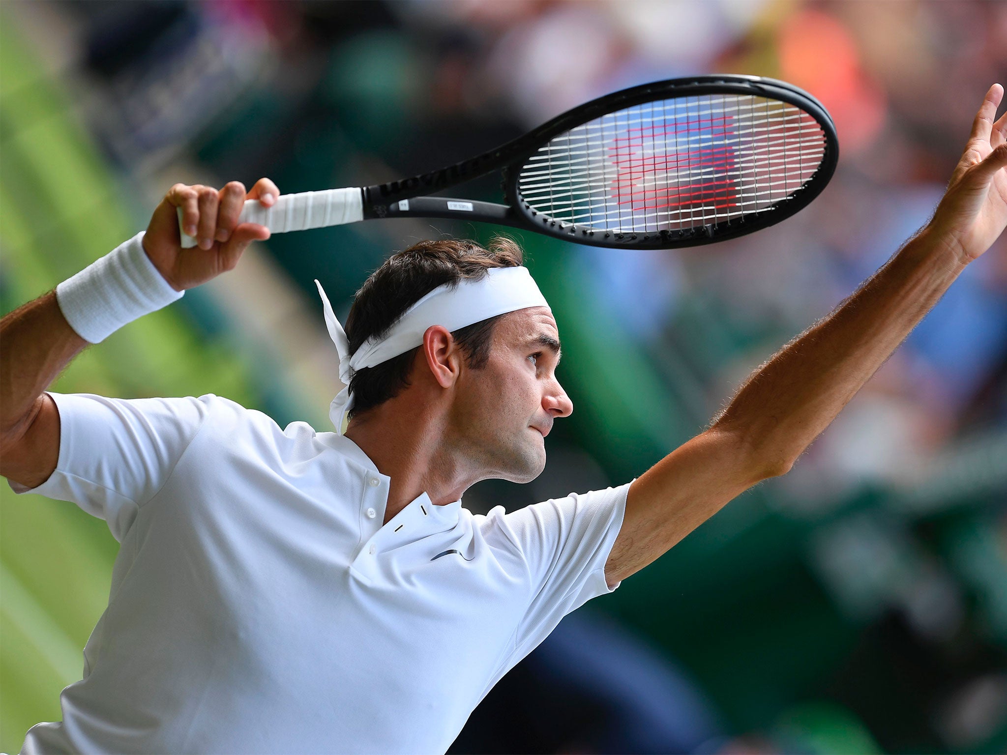 Roger Federer serves in his Wimbledon first-round victory