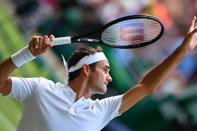 Roger Federer serves in his Wimbledon first-round victory
