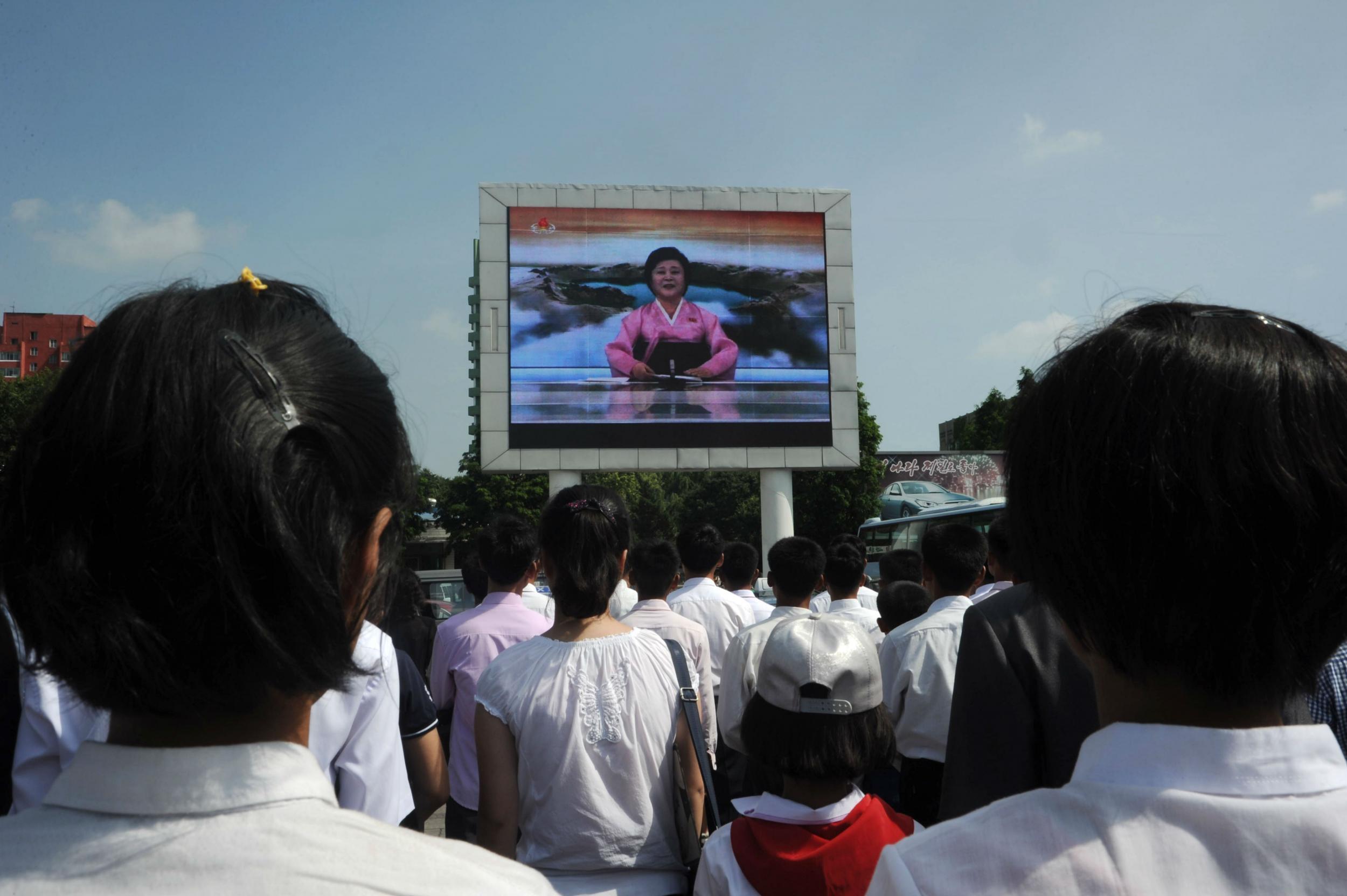 Pyongyang residents watch news of the successful launch of the intercontinental ballistic missile Hwasong-14 on a big screen on Tuesday