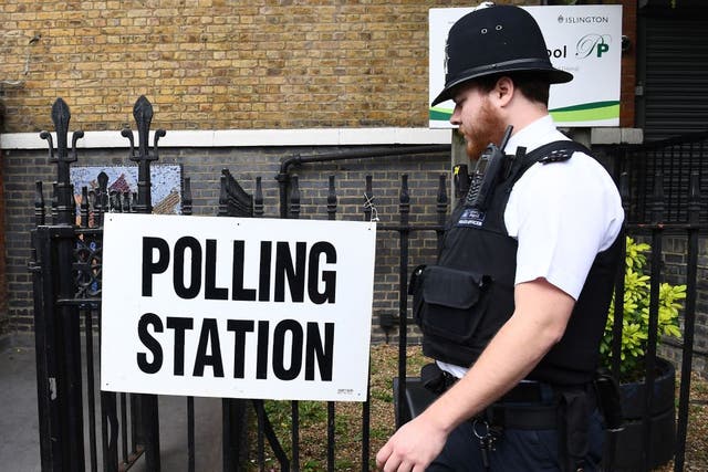 A police officer arrives at a polling station in London on 8 June 2017