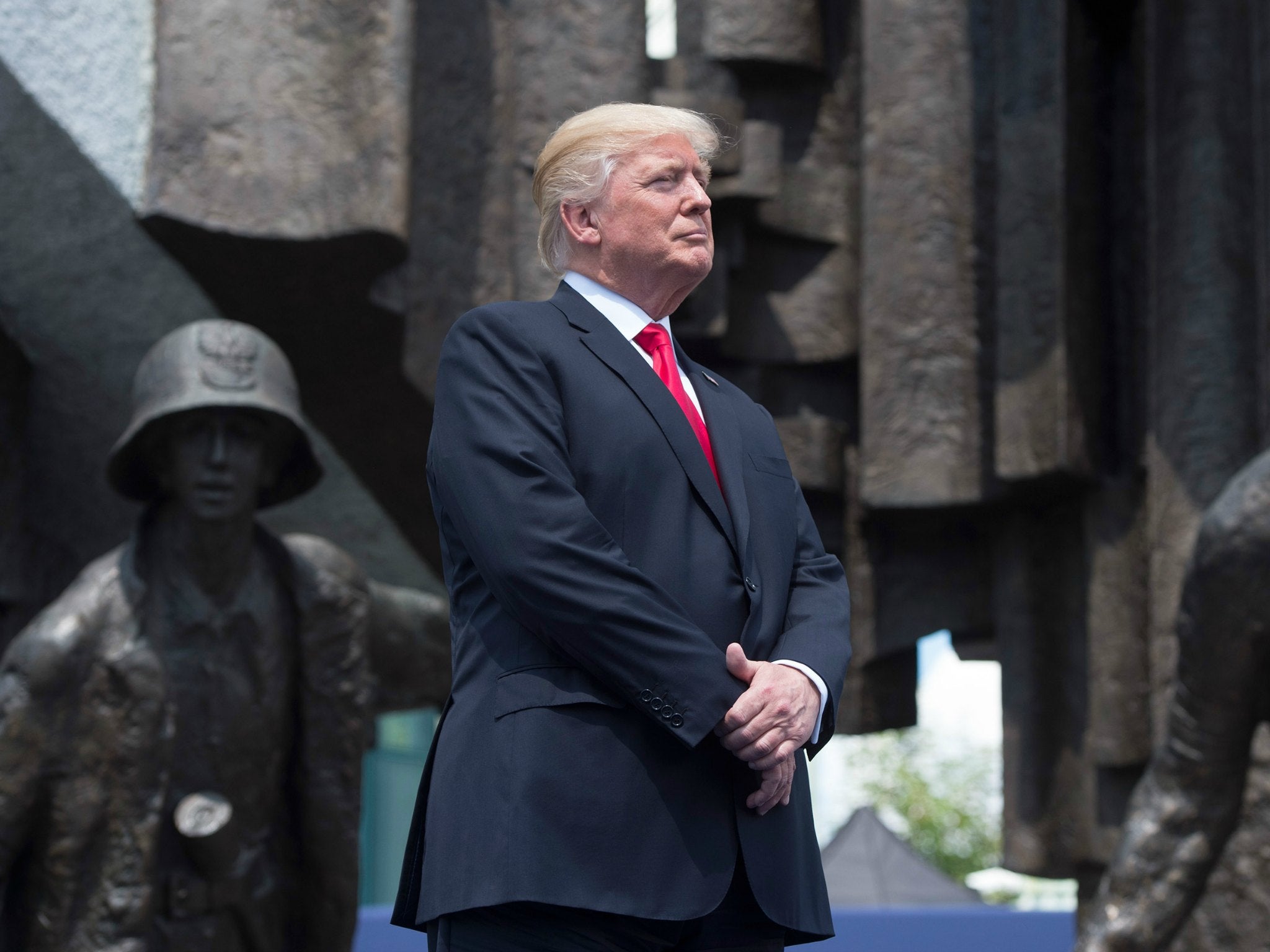 President Donald Trump stands in front of the Warsaw Uprising monument in Krasinski Square ahead of his address