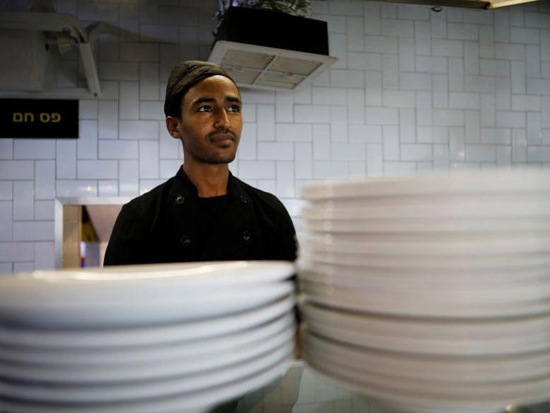 Teklit Michael, 29, an asylum seeker from Eritrea, works in the kitchen of a restaurant in Tel Aviv, Israel June