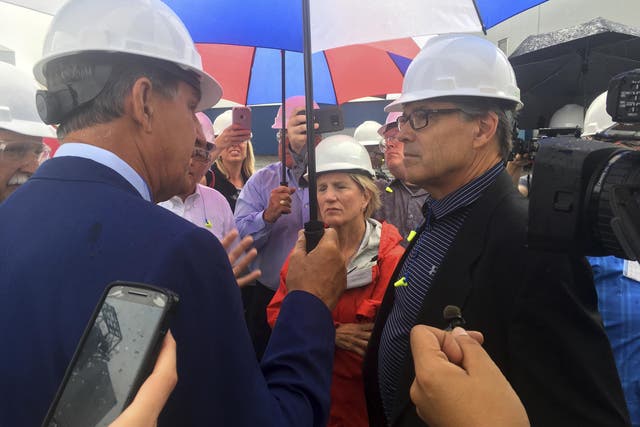 Energy Secretary Rick Perry, right, talks with Democratic Senator Joe Manchin and Republican Senator Shelley Moore Capito outside the coal-burning Longview Power Plant in Maidsville, West Virginia