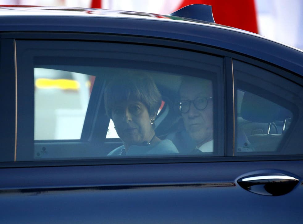 Theresa May arrives at the G20 in Hamburg, with husband Philip