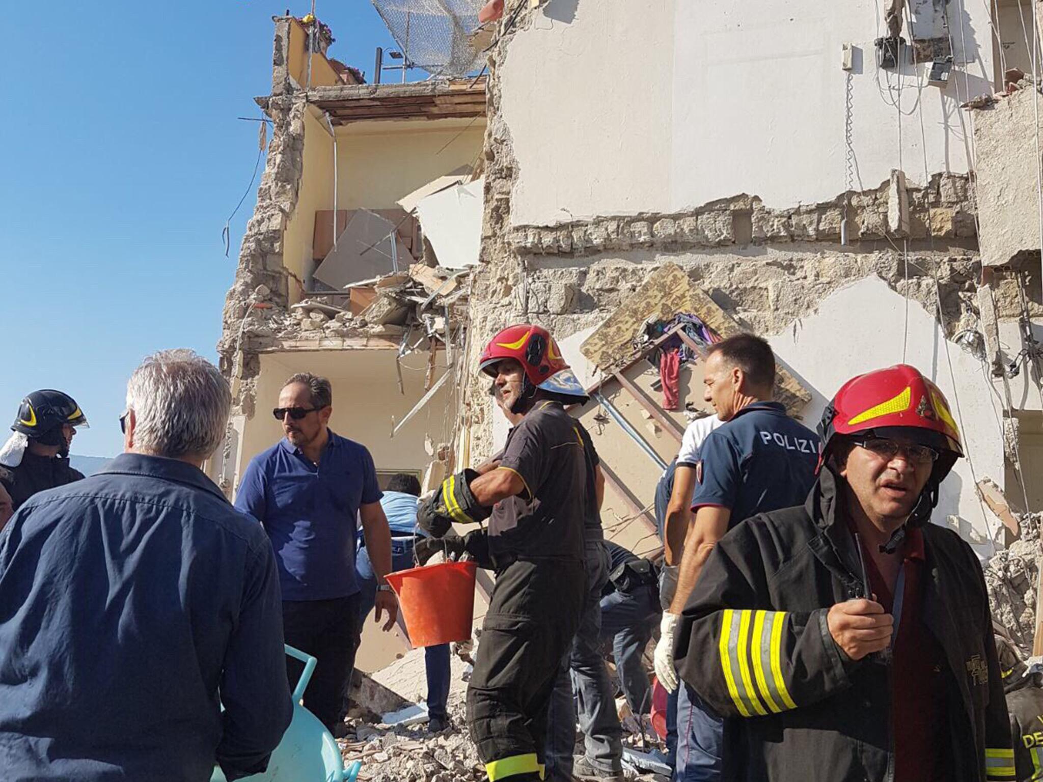 Emergency workers inspect the rubble of an apartment block in Torre Annunziata, Italy