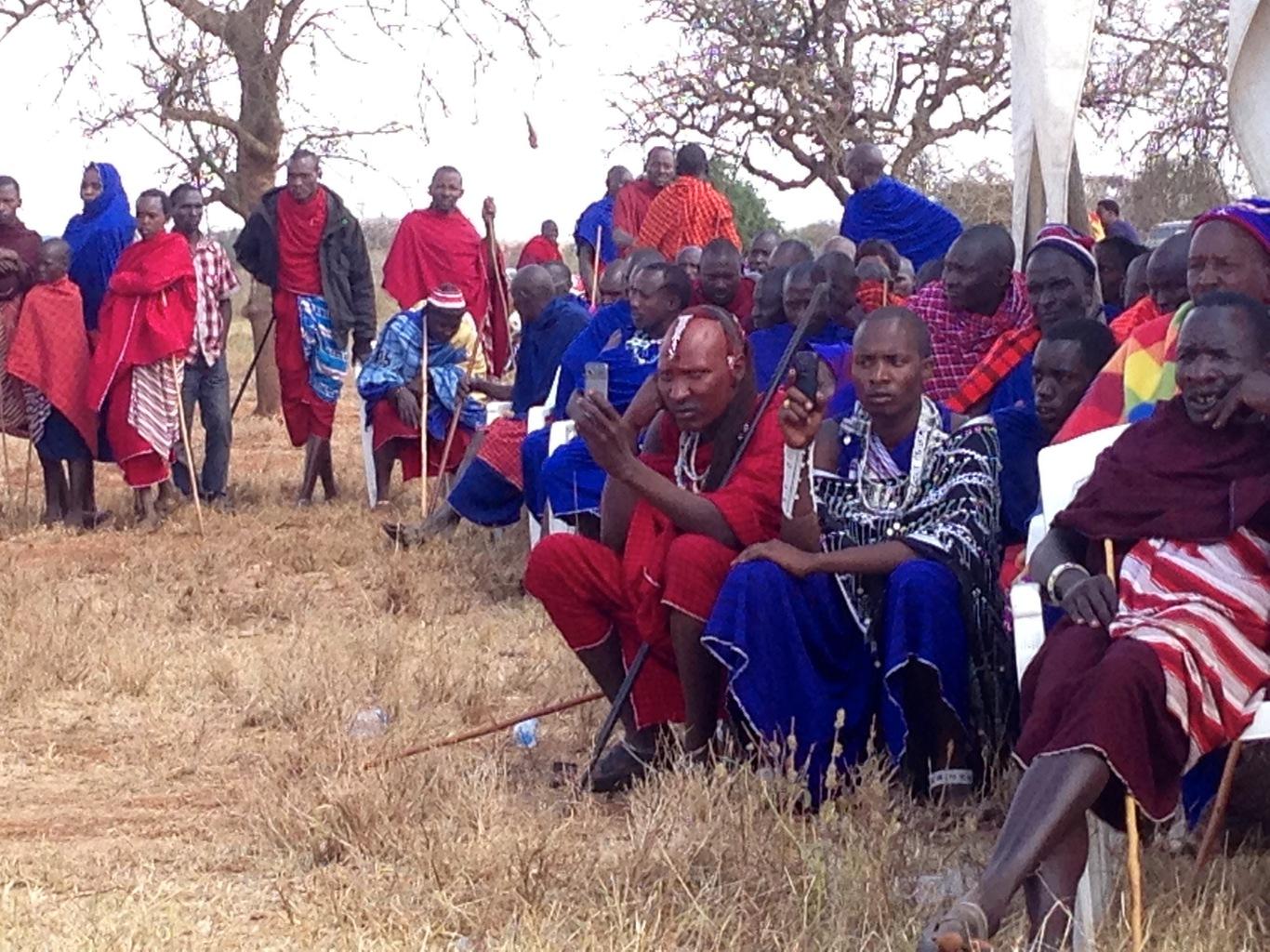 Young warriors use phones to take pics at a political meeting (Timothy Baird)