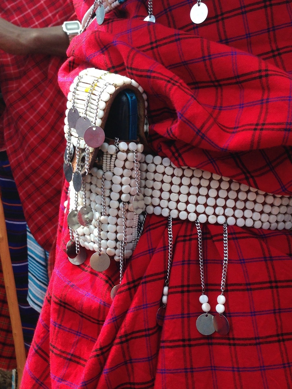 A Maasai man accessorises with a beaded phone holder