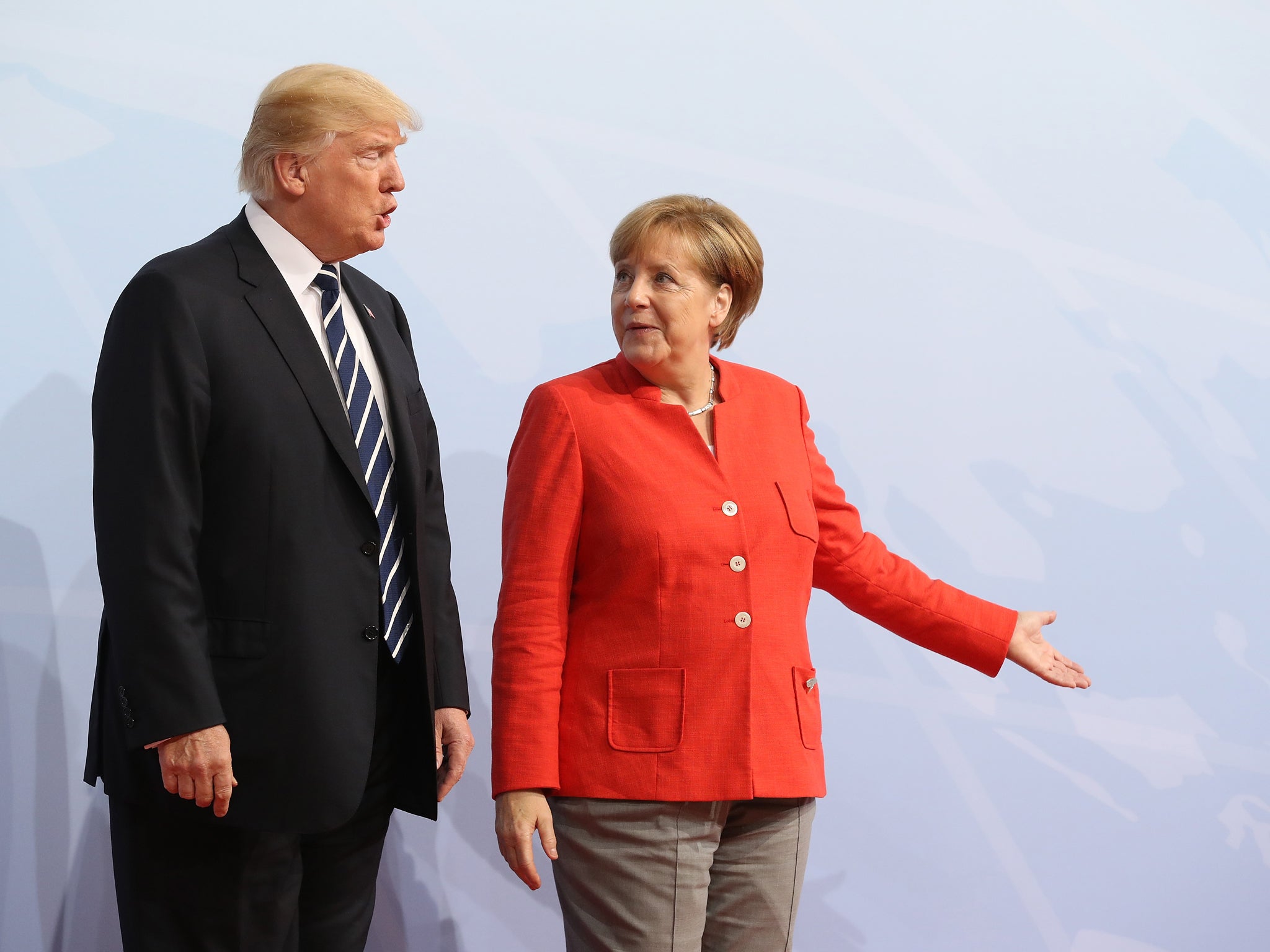 German Chancellor Angela Merkel greets US President Donald Trump upon his arrival for the first day of the G20 economic summit in Hamburg, Germany