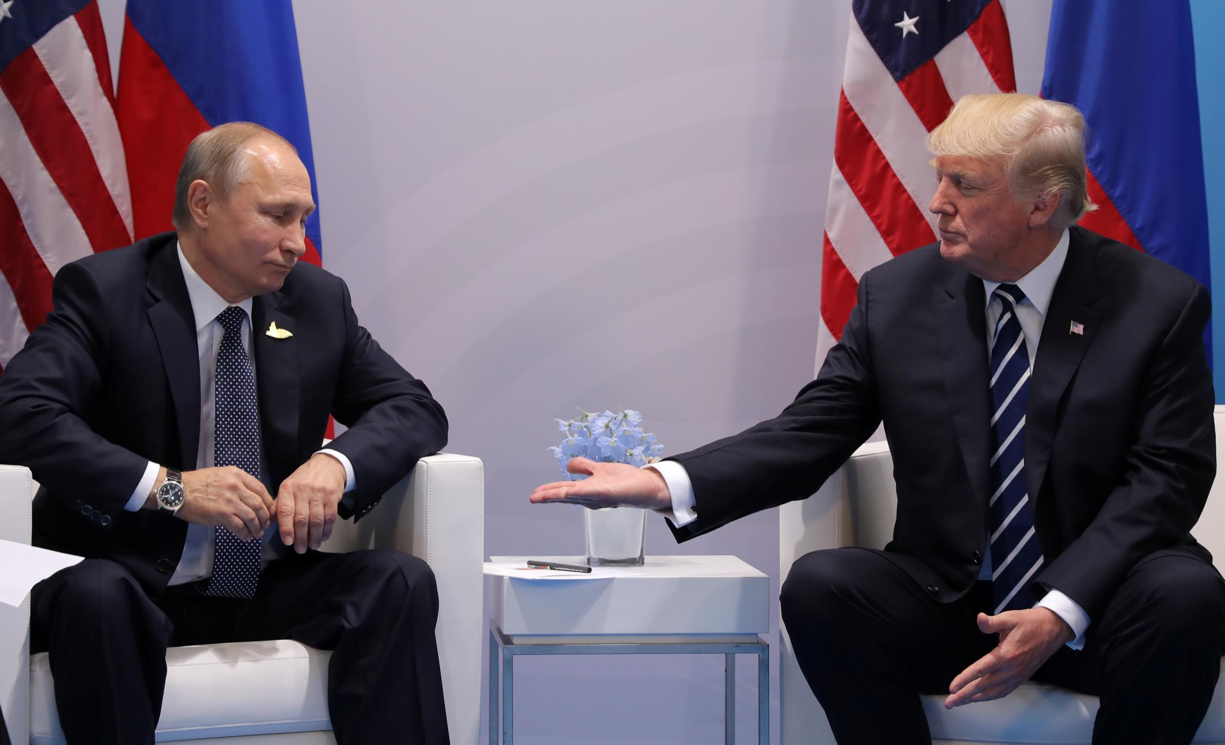 Russian leader Vladimir Putin (left) meeting US president Donald Trump