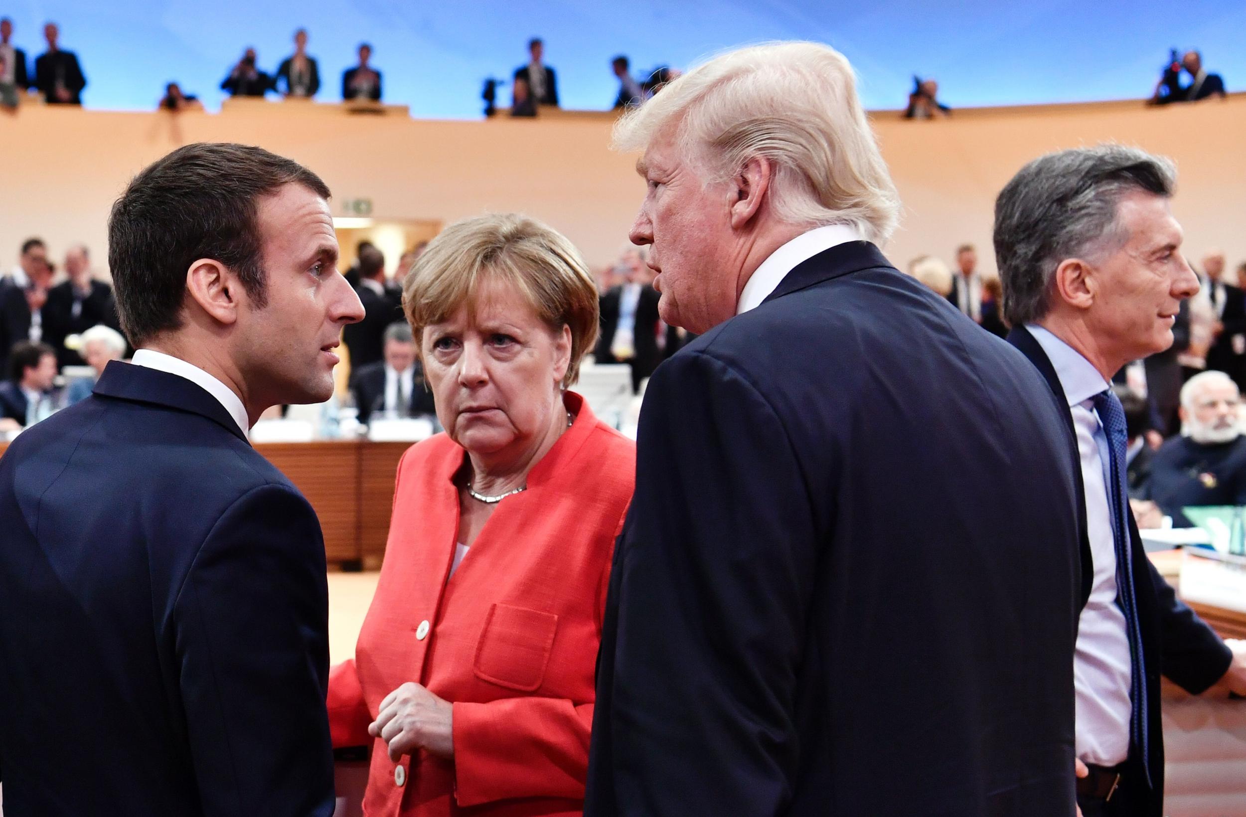 Mr Macron jumped through world leaders to stand next to Mr Trump