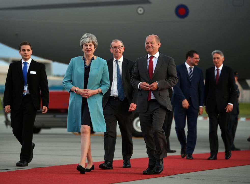 Prime Minister Theresa May and husband Philip, followed by Chancellor Philip Hammond, arrives in Hamburg for the G20 leaders' summit