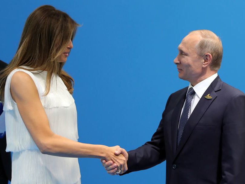 Russian President Vladimir Putin (R) and US First Lady Melania Trump (L) shake hands as they meet on the sidelines of the G20 summit in Hamburg, Germany, 07 July 2017.