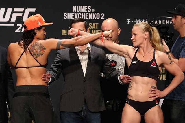 Amanda Nunes of Brazil and Valentina Shevchenko of Kyrgyzstan face off during the weigh-in