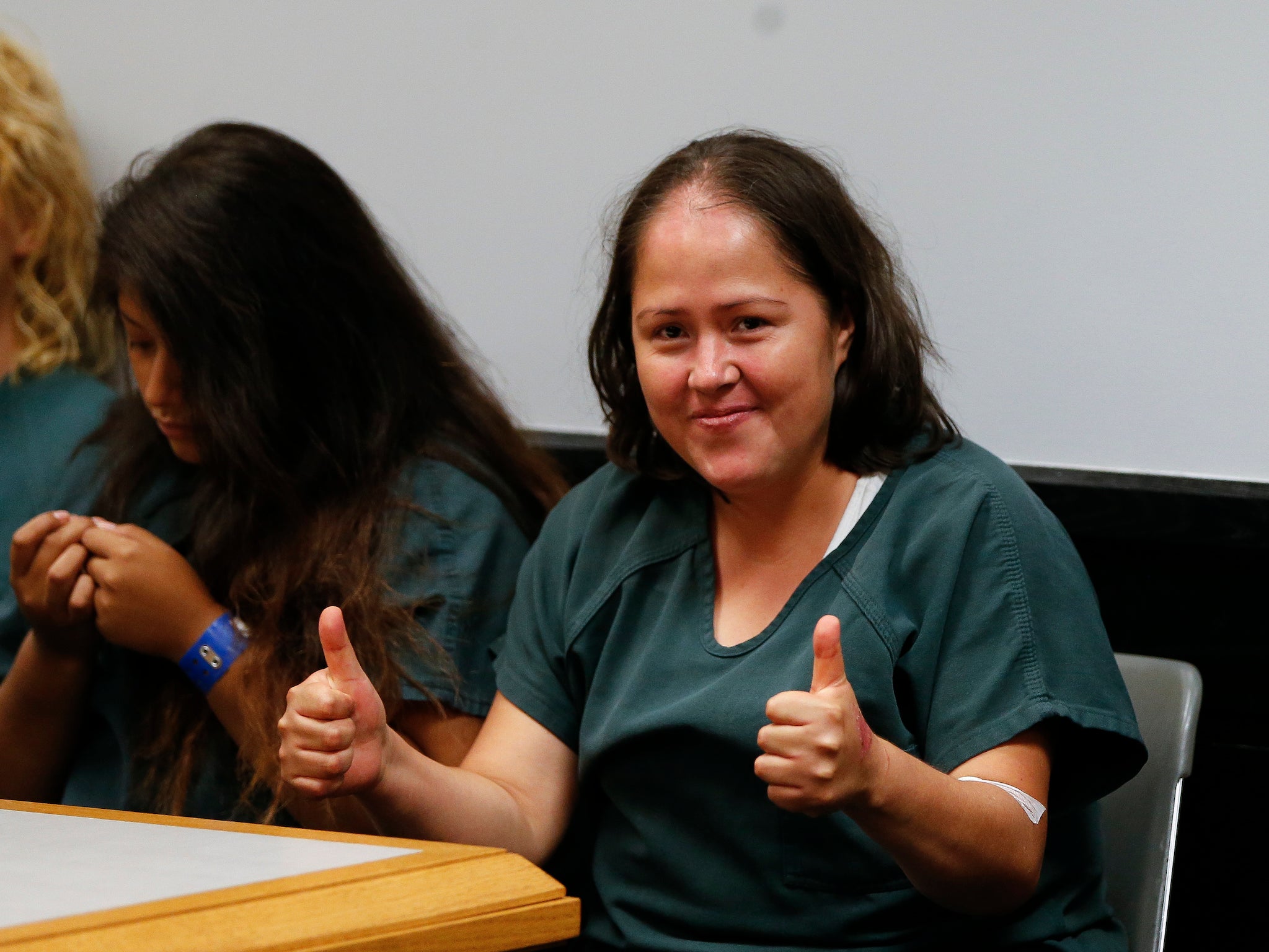 Isabel Martinez gestures towards news cameras during her first court appearance Lawrenceville