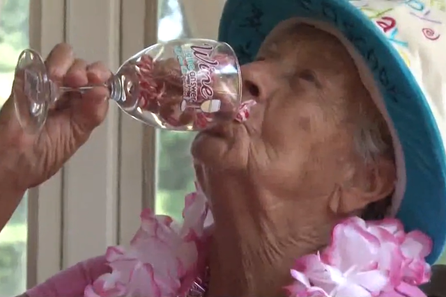 Florence Bearse enjoys her favourite tipple on her 100th birthday