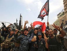 Iraqi troops celebrate defeat of Isis in Mosul as mopping up continues